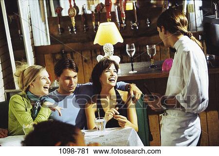 people, smiling, laughing, bar, friends, restaurant View Large Photo Image Stock Image - people, smiling, laughing, bar, friends, restaurant. Fotosearch