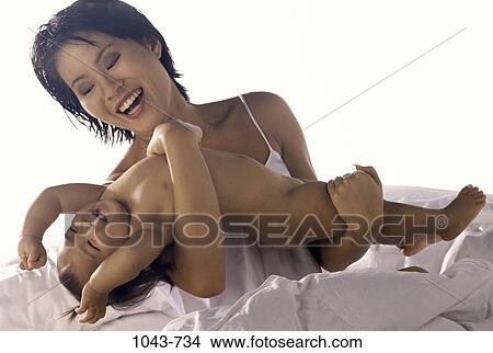 people, smiling, playing, Asian, mother, bed View Large Photo Image Picture - people, smiling, playing, Asian, mother, bed. Fotosearch