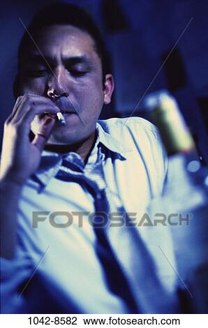 Stock Image - people, smoke, bottle, Hispanic, cigarette, drinking. Fotosearch