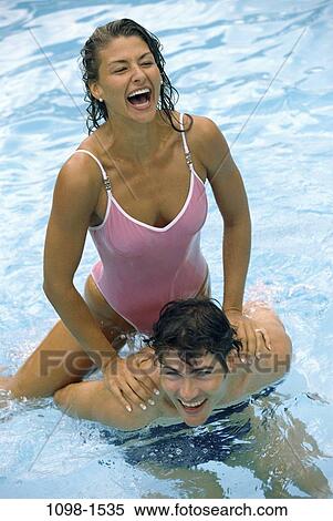 people, swim, pool, playing, couple, swimming, laughing View Large Photo Image Stock Photography - people, swim, pool, playing, couple, swimming, laughing. Fotosearch