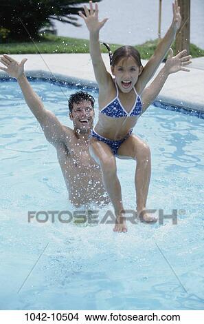 Picture - people, swim, pool, playing, swimming, outdoors, family. Fotosearch