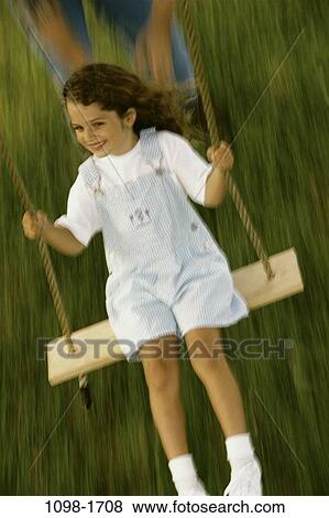 people, swinging, girl, swing, outdoors, overalls, carefree View Large Photo Image Stock Photo - people, swinging, girl, swing, outdoors, overalls, carefree. Fotosearch