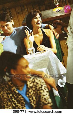Stock Image - people, table, couple, gesturing, dining out, restaurant, waiter. Fotosearch