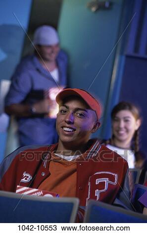 Stock Image - people, theater, teens, movie, indoors, Caucasian. Fotosearch