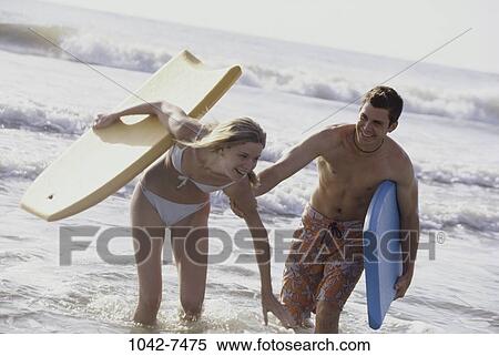 people, water, smiling, playing, couple, beach View Large Photo Image Stock Photography - people, water, smiling, playing, couple, beach. Fotosearch
