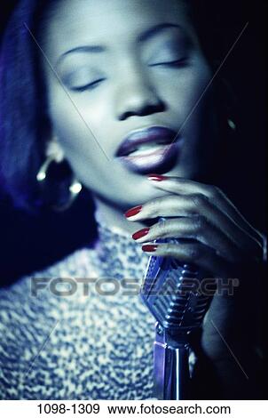 Stock Photo - people, woman, entertainment, singing, eyes closed, brunette. Fotosearch