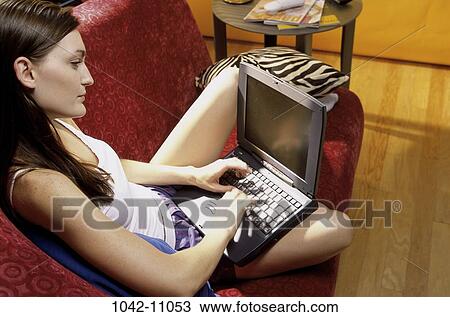 people, woman, sitting, computer, laptop, typing, couch View Large Photo Image Stock Image - people, woman, sitting, computer, laptop, typing, couch. Fotosearch