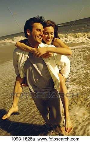 sand, people, playing, walking, couple, beach, riding View Large Photo Image Stock Image - sand, people, playing, walking, couple, beach, riding. Fotosearch