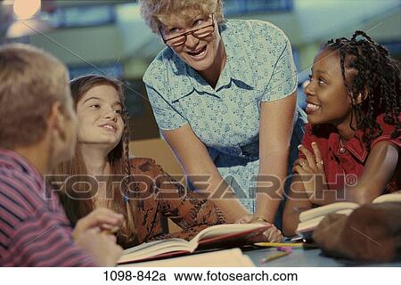 Stock Image - teacher, books, studying, library, lifestyles, joyous, teamwork. Fotosearch