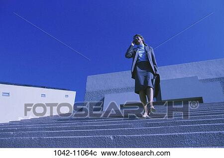 Stock Image - telephone, phone, business, outdoors, cell phone, cell, Businesspeople outdoors phone. Fotosearch