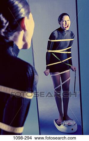 woman, tape, Hispanic, measurement, mirror, health, defeat View Large Photo Image Picture - woman, tape, Hispanic, measurement, mirror, health, defeat. Fotosearch
