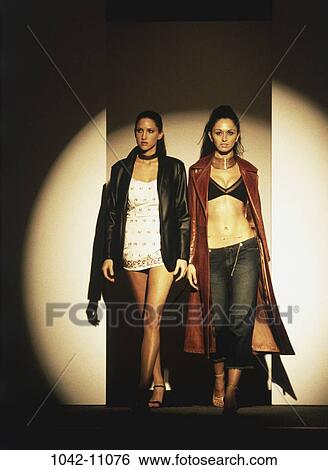 Stock Photograph - women, people, industry, walking, spotlight, Hispanic, brunette. Fotosearch