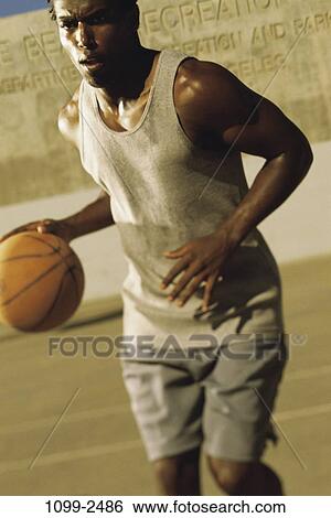 Stock Photograph - ball, sports, basketball, dedication, focused. Fotosearch