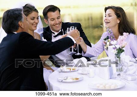 Stock Image - celebration, toasting, joyous, family, beginnings, wedding, tuxedo. Fotosearch