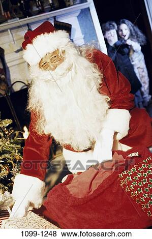 Stock Photo - Christmas, beard, children, giving, delivering, catch. Fotosearch