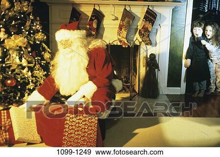 Christmas, fireplace, gifts, presents, children, giving View Large Photo Image Stock Photo - Christmas, fireplace, gifts, presents, children, giving. Fotosearch