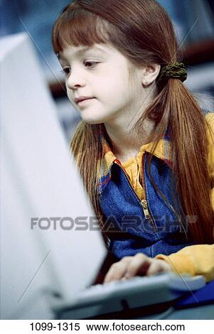 classroom, smiling, typing, sitting, busy, girl, attentive View Large Photo Image Stock Photography - classroom, smiling, typing, sitting, busy, girl, attentive. Fotosearch