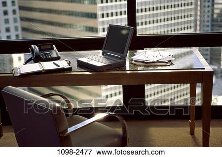 Stock Photo - desk, chair, window, computer, laptop, business, furniture. Fotosearch