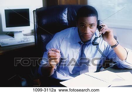 Stock Image - desk, monitor, telephone, eyeglasses, listening, computer. Fotosearch