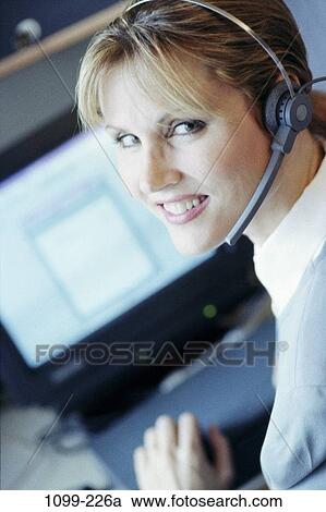 Stock Image - desk, woman, headset, telephone, phone, business, concepts. Fotosearch