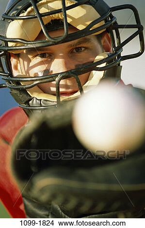 Picture - face, concentration, baseball, catching, mask, concentrating. Fotosearch
