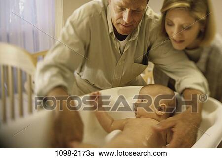 family, people, nurturing, crib, baby, attentive View Large Photo Image Stock Image - family, people, nurturing, crib, baby, attentive. Fotosearch