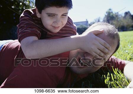 grass, people, eyes, playing, covering, outdoors, family View Large Photo Image Stock Photography - grass, people, eyes, playing, covering, outdoors, family. Fotosearch