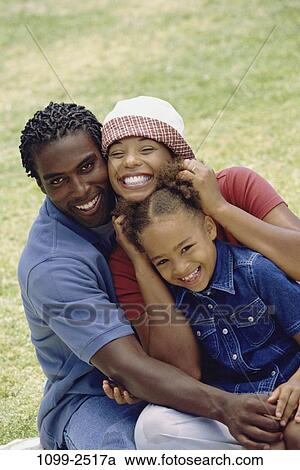 grass, people, smiling, hat, outdoors, hugging, unity View Large Photo Image Stock Image - grass, people, smiling, hat, outdoors, hugging, unity. Fotosearch