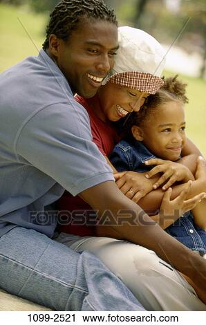 grass, people, smiling, hat, sitting, outdoors, hugging View Large Photo Image Stock Image - grass, people, smiling, hat, sitting, outdoors, hugging. Fotosearch