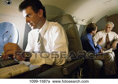 group, men, airplane, talking, eyeglasses, laptop, typing View Large Photo Image Stock Image - group, men, airplane, talking, eyeglasses, laptop, typing. Fotosearch