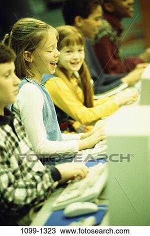 Stock Image - group, multiethnic, people, school, typing, future, diversity. Fotosearch