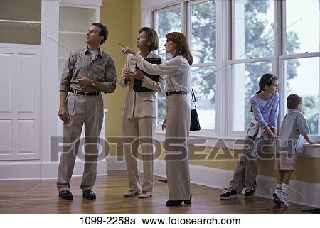 Stock Image - group, people, home, moving, considering, pointing. Fotosearch