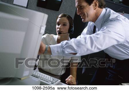 instructing, desk, headset, computer, business, Middle-aged, explaining View Large Photo Image Stock Image - instructing, desk, headset, computer, business, Middle-aged, explaining. Fotosearch
