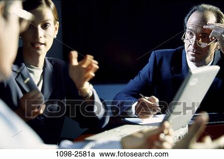 Stock Image - meeting, group, eyeglasses, laptop, business, Middle-aged, indoors. Fotosearch