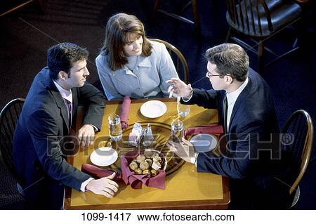 Stock Photo - meeting, group, water, table, business, restaurant, plates. Fotosearch