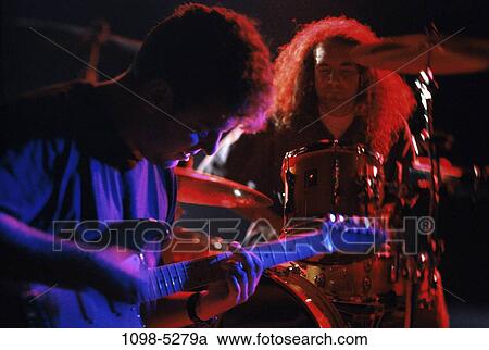 Stock Image - men, performance, performing, indoors, band, musicians, drummer. Fotosearch