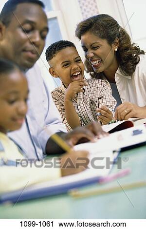 Stock Image - mother, people, sitting, pencil, smiling, homework, attentive. Fotosearch