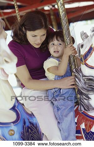 mother, riding, amusement, entertainment, family, overalls, daughter View Large Photo Image Picture - mother, riding, amusement, entertainment, family, overalls, daughter. Fotosearch