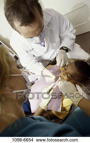Picture - multiethnic, patient, dentist, doctor, equipment, tools, health. Fotosearch
