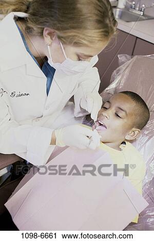 Stock Image - multiethnic, patient, dentist, doctor, cleaning, health, professional. Fotosearch