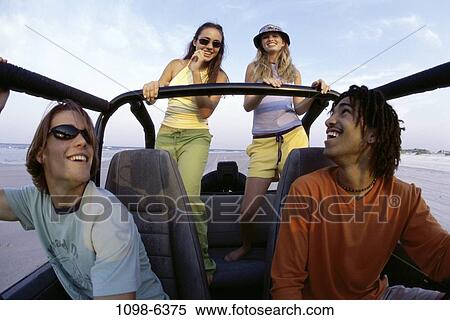 Stock Photography - multiethnic, people, car, driving, beach, sunglasses. Fotosearch