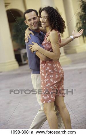 Stock Image - multiethnic, people, plants, smiling, couple, Hispanic, laughing. Fotosearch