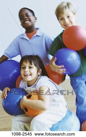 multiethnic, people, smiling, playing, sitting, balls, holding View Large Photo Image Stock Photography - multiethnic, people, smiling, playing, sitting, balls, holding. Fotosearch