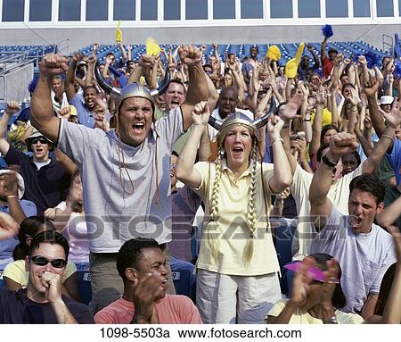 Stock Image - multiethnic, people, sports, cheering, crowd, stadium, spectators. Fotosearch