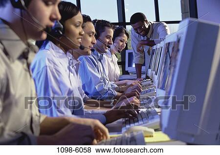 Stock Photo - multiethnic, people, talking, typing, business, computers, desks. Fotosearch
