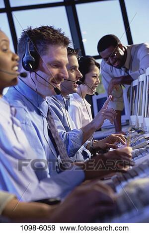 Stock Photo - multiethnic, people, talking, typing, business, computers, desks. Fotosearch