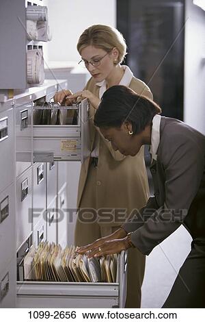 multiethnic, women, concentration, concentrating, business, serious, sorting View Large Photo Image Stock Photograph - multiethnic, women, concentration, concentrating, business, serious, sorting. Fotosearch