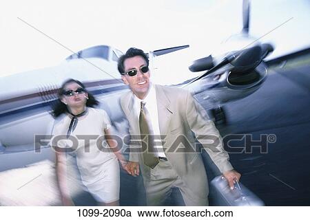 Stock Image - people, airplane, couple, sunglasses, stress, business. Fotosearch