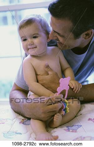 Stock Image - people, baby, family, father, parent, indoors, Father baby indoors. Fotosearch