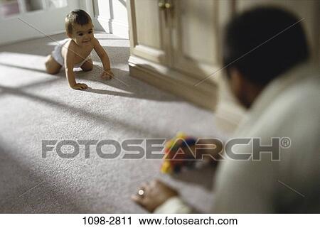 Stock Image - people, baby, floor, challenges, family, father. Fotosearch